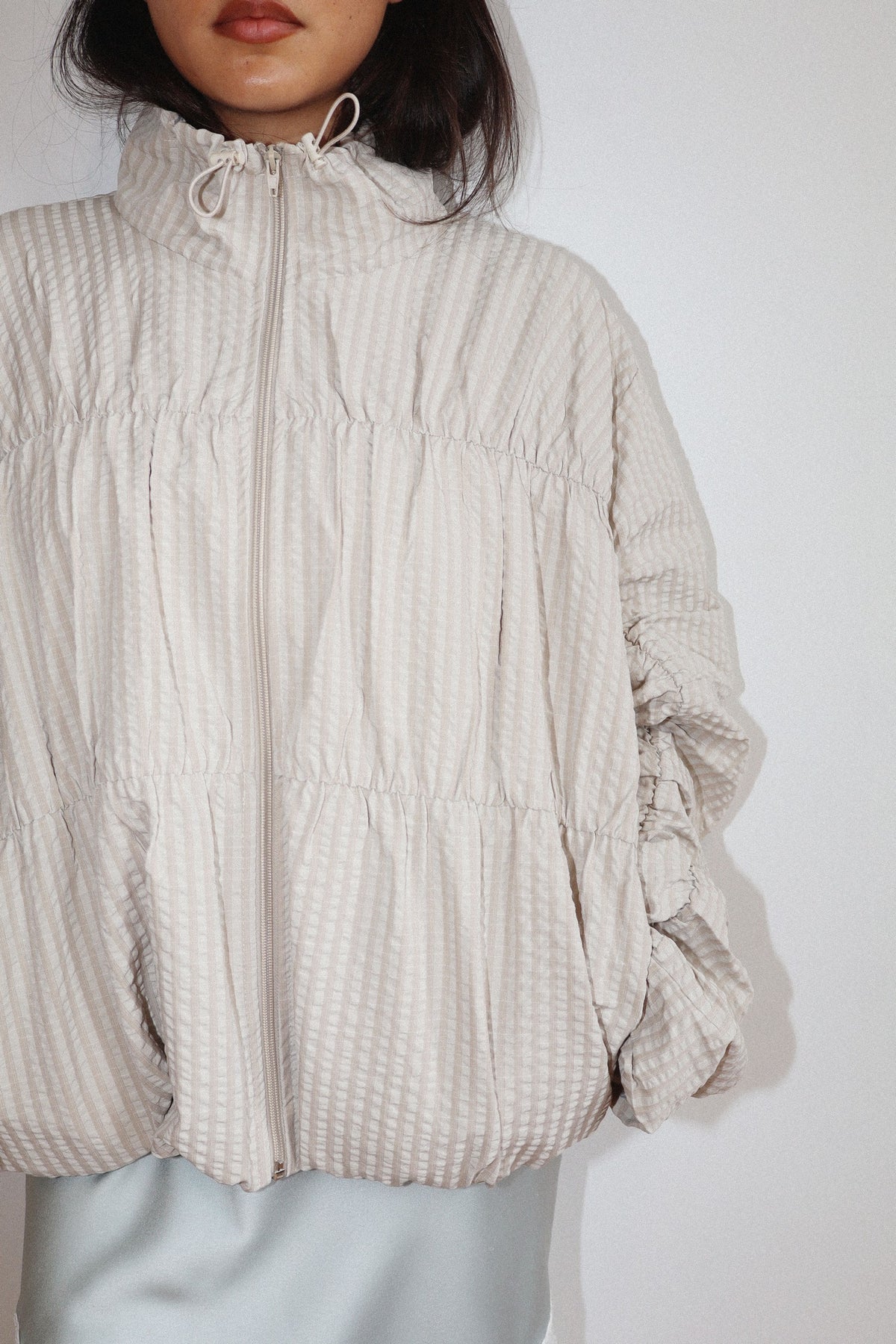 high neck beige textured zip-up jacket 