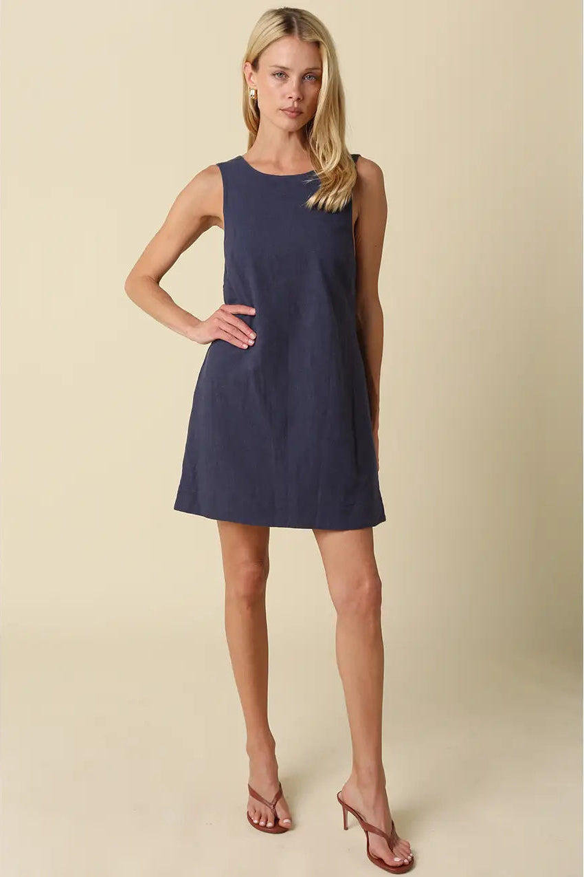 sleeveless, knee-length navy blue linen dress with open back