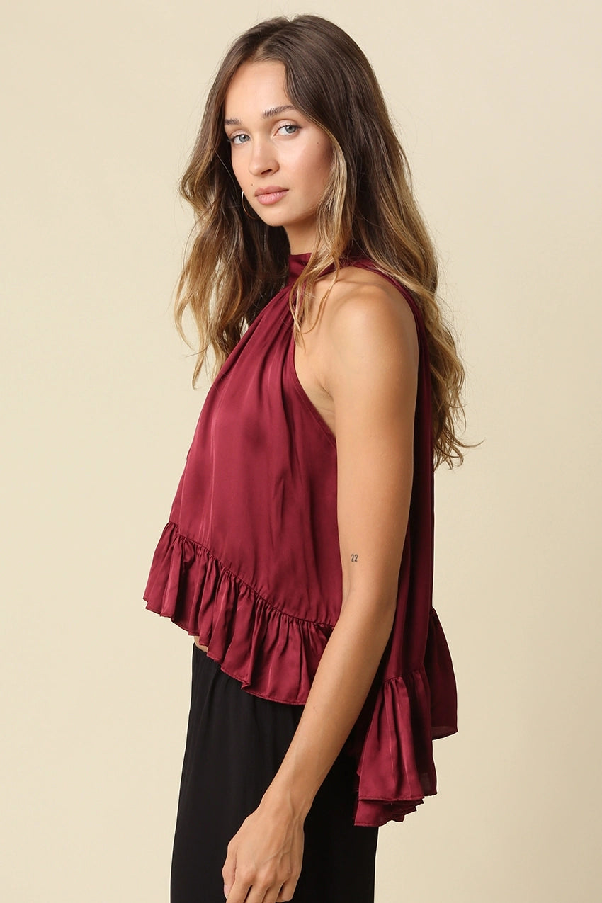 sleeveless satin high-neck top in deep burgundy with a ruffled hem